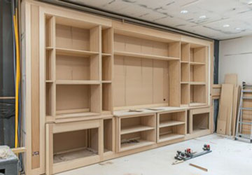 Unfinished bespoke media wall unit with shelving under construction